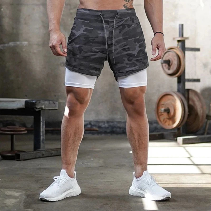 Camo men's 2-in-1 athletic shorts, featuring built-in compression liners and a secure side pocket for your phone or essentials. Designed for running, training, and gym workouts, they offer support, flexibility, and performanc
