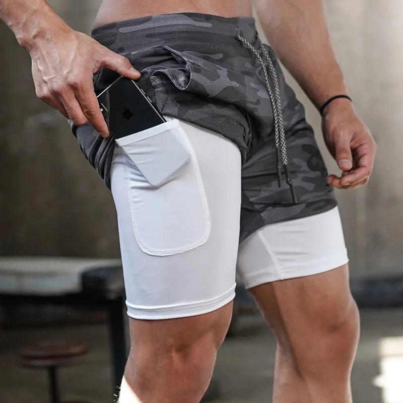 Camo men's 2-in-1 athletic shorts, featuring built-in compression liners and a secure side pocket for your phone or essentials. Designed for running, training, and gym workouts, they offer support, flexibility, and performanc